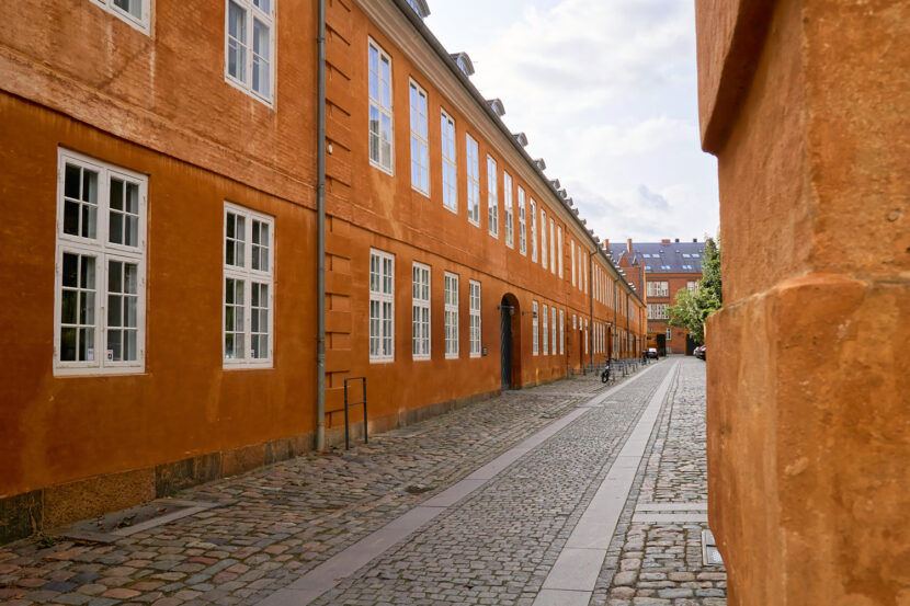 Historische Kopfsteinpflastergasse am Slotsholmskanalen in Kopenhagen mit charakteristischen Backsteinfassaden